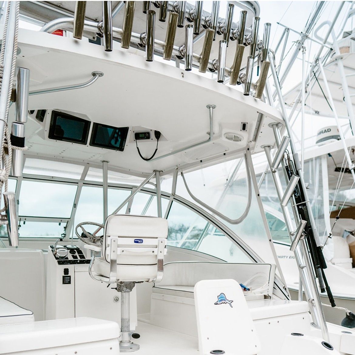 AIONA — fishing rods rigged and ready on charter vessel deck, Vanuatu